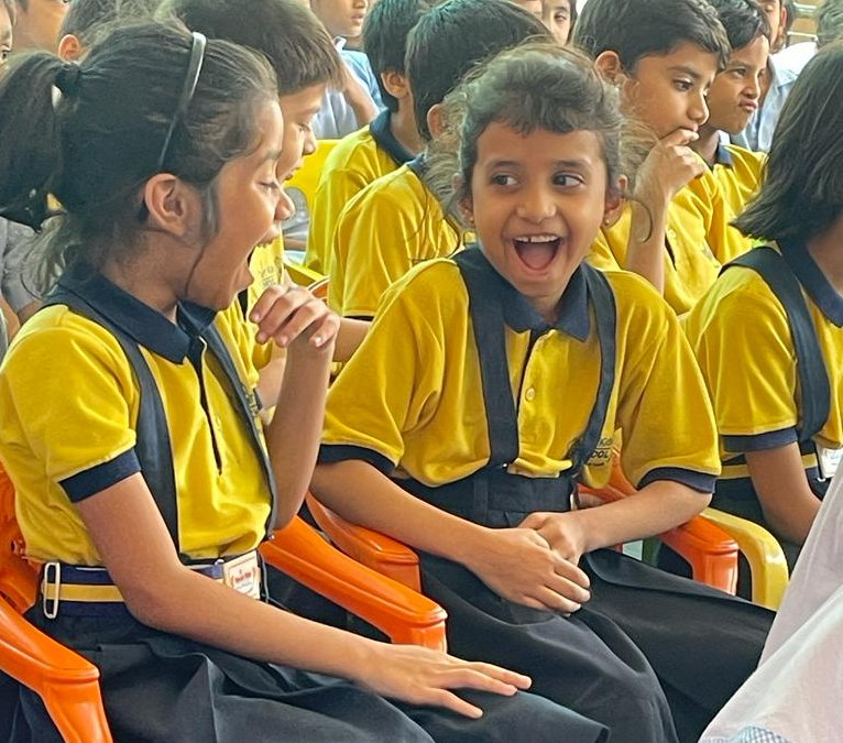 School children holding up their health-awareness drawings at a HOPE session